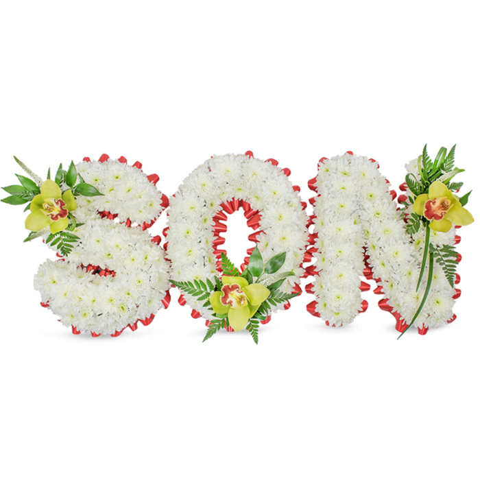 A refined and deeply respectful floral presentation spells 'SON' in bold, three-dimensional letters made from a sea of tiny, immaculate white chrysanthemums. The dense clusters of blooms give each letter a rounded, sculpted presence that reads soft to the eye and gentle to the touch, set simply against a white background to keep attention on the composition. Along the edges of the letters a vivid red ribbon is worked into a series of scalloped loops, the satin sheen of the ribbon forming a poignant border that contrasts with the chrysanthemums' matte white surfaces. Each letter is punctuated by a lime-green Cymbidium orchid - one on the upper left of the 'S', one cradled inside the lower part of the 'O', and a third near the top right of the 'N' - each orchid showing a warm reddish-brown mark within its throat and surrounded by lush green leaves and slender fern fronds that lend vertical lines and soft movement.
The overall effect, captured under soft, diffused lighting, balances solemnity with tenderness; the orchids' waxy texture and the chrysanthemum's cushion-like massing create depth and a quiet, comforting contrast. Speaking as a local florist familiar with Queensbury and the surrounding streets towards Kingsbury and Burnt Oak, this kind of personalised sympathy piece is chosen to convey unmistakable affection and remembrance at funeral services and graveside gatherings. The thoughtful placement of each accent, the crisp palette of white, red and green, and the handcrafted ribbon edge all speak to a careful, experienced floral hand crafting a fitting tribute for a beloved son.