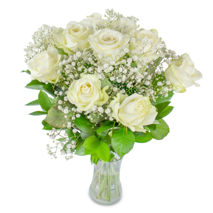 This composition of creamy white roses and fine baby's breath reads like a small poem in floral form: about a dozen roses with petals that open in soft, luminous layers, some fully unfurled and others holding an inner spiral of promise. Scattered through and around the main blooms, the tiny white flowers of Gypsophila form a gossamer veil, their pin-sized heads catching light to create a shimmering, almost starry texture against the larger, round blooms. The foliage beneath is a study in greens-from deep bottle-green leaves that anchor the bouquet to brighter lime-tinted sprigs that lift and freshen the silhouette-set within a clear glass vase that shows the orderly stems and the reassuring water level. The photograph's pristine white backdrop and gentle natural lighting accentuate the creamy undertones of the roses and the fragile quality of the baby's breath, giving the arrangement an air of quiet celebration and reflective beauty. For events in and around Queensbury-whether a small wedding near Canons Park, an anniversary supper, or a solemn remembrance-the bouquet speaks of restrained elegance and steady comfort. The scent is suggested rather than asserted, a whisper of fresh-cut roses that evokes early-morning walks along local streets or a pause in a sunny café by Queensbury Station. From a florist's perspective, assembling these stems is about balance: letting the airy gypsophila breathe around the roses while ensuring each bloom's face is visible, creating an arrangement that feels both timeless and intimately local.