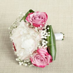 Elegance and romance meet local charm in this captivating hand-crafted bouquet, arranged on the gentle weave of a linen fabric that evokes the tranquil textures found throughout Queensbury homes. Spiralled pink roses take pride of place, their outer petals brushed with vivid fuchsia that seamlessly blends inward to soft blush and a hint of lavender-a palette that mirrors the first light over Canons Park. Nestled between them, a fully blossomed white peony unfolds in luxurious ruffles, offering creamy depth and an invitation to gently touch its pillowy softness. Scattered amongst these star blooms are sprays of dainty baby's breath, floating like tiny clouds and lending the design a whimsical softness. The bouquet's neatly wrapped stems peek from below, bound in a white satin ribbon that hints at celebrations close to home-from intimate registry weddings to joyful gatherings on Mollison Way. Broad, glossy green leaves, artfully wrapped around the bouquet's form, set a vibrant stage for the flowers' colour story to shine. Under even, natural light, every petal's texture and colour are lovingly brought to life, reflecting the careful hand of a local Queensbury florist. This composition is a meaningful choice for bridesmaids, wedding guests, or as an expressive gift, imbued with the freshness and style Flower Delivery Queensbury brings to every occasion.