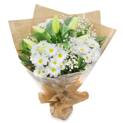An elegant hand-crafted bouquet is photographed against a clean white background, allowing every white and green detail to stand out as clearly as a bright day along Honeypot Lane in Queensbury. At the forefront are clusters of daisy-like white chrysanthemums, each bloom presenting a ring of neat, velvety petals that frame a fresh yellow-green centre. Their abundance forms a generous, rounded dome that feels both soothing and inviting, like a soft embrace. Rising through this sea of daisies are several elongated lily buds, their petals still closed, shaded in pale green with a faint blush of creamy white along the tips. The lilies tilt upwards with quiet dignity, a graceful symbol of hope and the future opening of fragrant flowers. Between the larger blooms, delicate sprigs of baby's breath emerge, each tiny white blossom perched on wiry stems, adding a lace-like, cloud-soft texture that lightens the whole design. Deep green foliage cradles the arrangement, its glossy leaves overlapping and curving around the flowers to provide structure, depth, and a rich contrast to the white blossoms. The stems are carefully bound and wrapped in layers of brown kraft paper and clear cellophane, the kraft lending a rustic, natural warmth and the cellophane giving a polished, protective finish suited for careful delivery across Queensbury and the surrounding HA8 neighbourhoods. The bouquet conveys a mood of serenity, respect, and understated beauty, making it an ideal floral tribute for sending sympathy to a local chapel, offering comfort at home, or accompanying a thoughtful message during a difficult time.