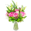 A bright, carefully composed bouquet of deep pink roses and white lilies sits in a simple clear glass vase against a clean white background, the image pared back to celebrate texture and colour. Several large roses are fully open, their velvety petals layered in shades from soft blush to richer fuchsia, each curl of petal catching the light like satin. Interspersed are elegant white lily buds-some still tightly furled, others gently parting to reveal the first sweep of trumpet-shaped white-offering a sense of promise and unfolding movement. The blooms sit amid generous green foliage: broader glossy leaves that frame the composition and finer, lighter-green sprigs that add air and rhythm so the arrangement reads as lush rather than stiff. Small, darker burgundy or reddish-brown accent buds and foliage are threaded through the greens, giving the bouquet visual depth and a whisper of autumn warmth against the cooler pinks and whites. The transparent vase, slightly tapered toward the base, holds clear water where the neatly trimmed stems are visible, reinforcing the freshness and the florist's clean finish. Soft, bright studio lighting flattens shadows and makes colours pop, suggesting a picture meant for a product page or a celebratory gift listing. As a local florist with hands-on experience, I imagine this arrangement finding a home on a Queensbury mantelpiece or a dining table before a birthday or anniversary supper-its scent a gentle blend of rose sweetness and the powdery lift of lilies, a gesture that reads as both joyful and thoughtfully refined.