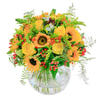 Radiating the brilliance of a sunny Queensbury afternoon, this joyful bouquet brings the effervescent spirit of summer and early autumn right indoors. At its heart, bold sunflowers display velvety, dark centres, each surrounded by golden petals that seem to spread light in all directions-evoking the cheerful atmosphere of Alexandra Avenue on market day. Interwoven are bright yellow roses, their creamy, layered blooms gently unfolding to reveal a story of happiness and celebration. Vibrant orange blossoms and glossy clusters of red berries punctuate the arrangement, sparking playful contrast against fresh, feathered greenery and delicate ferns that evoke a gentle park breeze. The arrangement rests in a clear, rounded glass vase, its stems artfully tangled as if freshly gathered from a local field. Fresh, lightly sweet scents rise from the combination of blooms and foliage, reminiscent of strolling through a sunlit garden in Queensbury. Expertly designed to uplift, this bouquet brings warmth and radiance-perfect for marking a milestone, sending heartfelt thanks, or simply filling a home with a burst of cheerful, natural beauty.