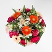 This exuberant bouquet is a celebration of colour and tactile beauty, expertly designed to capture life's happiest moments in Queensbury. At its vibrant heart, orange gerberas burst forth, their petals shimmering with a sunlit radiance reminiscent of mornings past the pond at Roe Green. Surrounding them, plush magenta carnations and blush roses create a sumptuous tapestry, their velvety surfaces inviting you to imagine the sensation of pressing petals between your fingertips. Interwoven throughout are snowy clusters of white alstroemeria and miniature daisies, which lend a sense of freshness as if touched by dawn's first light. Abundant greenery-shiny, rich, and perfectly arranged-envelops the composition without overwhelming it, echoing the fullness of Queensbury's tree-lined streets. Old and new floral favourites harmonise in a palette thoughtfully chosen for warmth, optimism, and artistic flair. Each detail, from the lingering hint of rose and carnation fragrance to the expert layering, reflects the care of a local florist well-versed in the spirit and seasons of Queensbury. Perfect for birthdays or any exuberant celebration, this bouquet offers both a visual feast and a gentle nod to the natural beauty right outside your door.