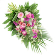 A beautifully composed sympathy spray stretches diagonally across a white background, its graceful shape moving from a dense cluster of stems at the upper left into a gentle cascade of flowers and greenery that narrows toward the lower right, like a soft bow of respect. The colour palette centres on tender pinks, rich fuchsias, and purples, highlighted by clean whites and grounded by varied shades of green. Large gerbera daisies, in tones from blush pastel to vivid magenta, catch the eye first, their open, circular faces symbolising brightness amid sadness. Nestled among them are graceful pink roses, each bloom with layered, spiralling petals that suggest enduring affection and heartfelt memory. Fluffy white flowers-likely small carnations or chrysanthemums-fill spaces between the larger blooms, providing both structure and a luminous, comforting glow. Scattered throughout, delicate white daisy-like fillers bounce lightly between stems, evoking small wildflowers one might notice in green spaces around Queensbury and adding a whimsical, airy touch. Clusters of glossy red hypericum berries are placed strategically, introducing rounded forms and a deeper accent of colour that enriches the design. The floral elements are supported by a lush tapestry of foliage: broad, shiny dark leaves create a strong base, feathery ferns bring soft motion, and silvery eucalyptus adds a cool, contemporary note and the suggestion of a clean, herbal fragrance. From the lower right, long palm fronds sweep outward, reinforcing the flowing line and giving the tribute a sense of quiet movement. Suitable as a casket spray or key memorial arrangement for services in Queensbury, this carefully crafted design expresses sympathy, remembrance, and gentle comfort to grieving families.