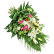 A sweeping, diagonal spray of sympathy flowers that reads like a quiet, floral poem - arranged to flow from the top-left toward the bottom-right against a clean white background. At its heart sit several large, luminous white lilies, their trumpet-shaped petals opening like soft lanterns and revealing pale golden stamens; some blooms are fully unfurled, others remain in elegant bud, suggesting both presence and hopeful remembrance. Interwoven among them are clusters of deep pink to fuchsia roses, their velvety petals partially opened to lend warmth and a gentle human pulse. Small, ruffled white spray carnations fill the spaces, softening edges and adding delicate texture. Bright, lime-green santini button chrysanthemums are scattered throughout as lively, moss-like spheres that lift the palette and bring a modern freshness to the traditional composition. Tiny scarlet hypericum berries punctuate the greenery, their vivid red berries offering small, natural sparks against the softer tones. The foliage is abundant and expertly layered: broad, glossy dark green leaves-some carefully folded to create graceful structural lines-sit beneath feathery, lighter-green sprays and long, palm-like fronds that trail down and to the right, emphasizing the cascade. The lighting reads soft and natural, catching the sheen on leaves and the satiny surface of rose petals, creating gentle highlights and quiet shadows. Crafted with the calm restraint appropriate for a funeral or memorial, this arrangement conveys peace, respect, and consolation. As a local creation from Queensbury florists, it feels especially suited for services near Queensbury tube, Kingsbury, or the Wembley area, offering thoughtful, fresh sympathy flowers prepared with close attention to texture and tone.